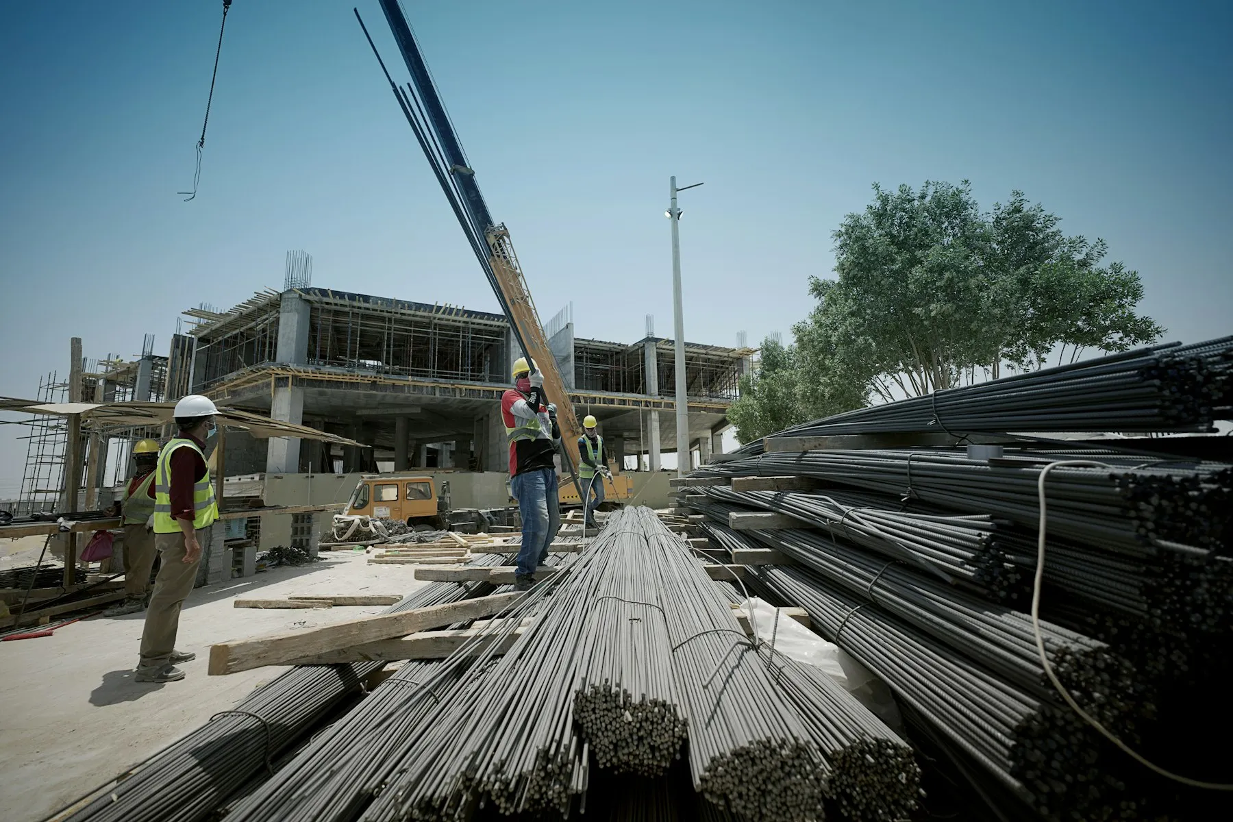 Cuadrilla de obra civil trabajando con acero de refuerzo en un sitio